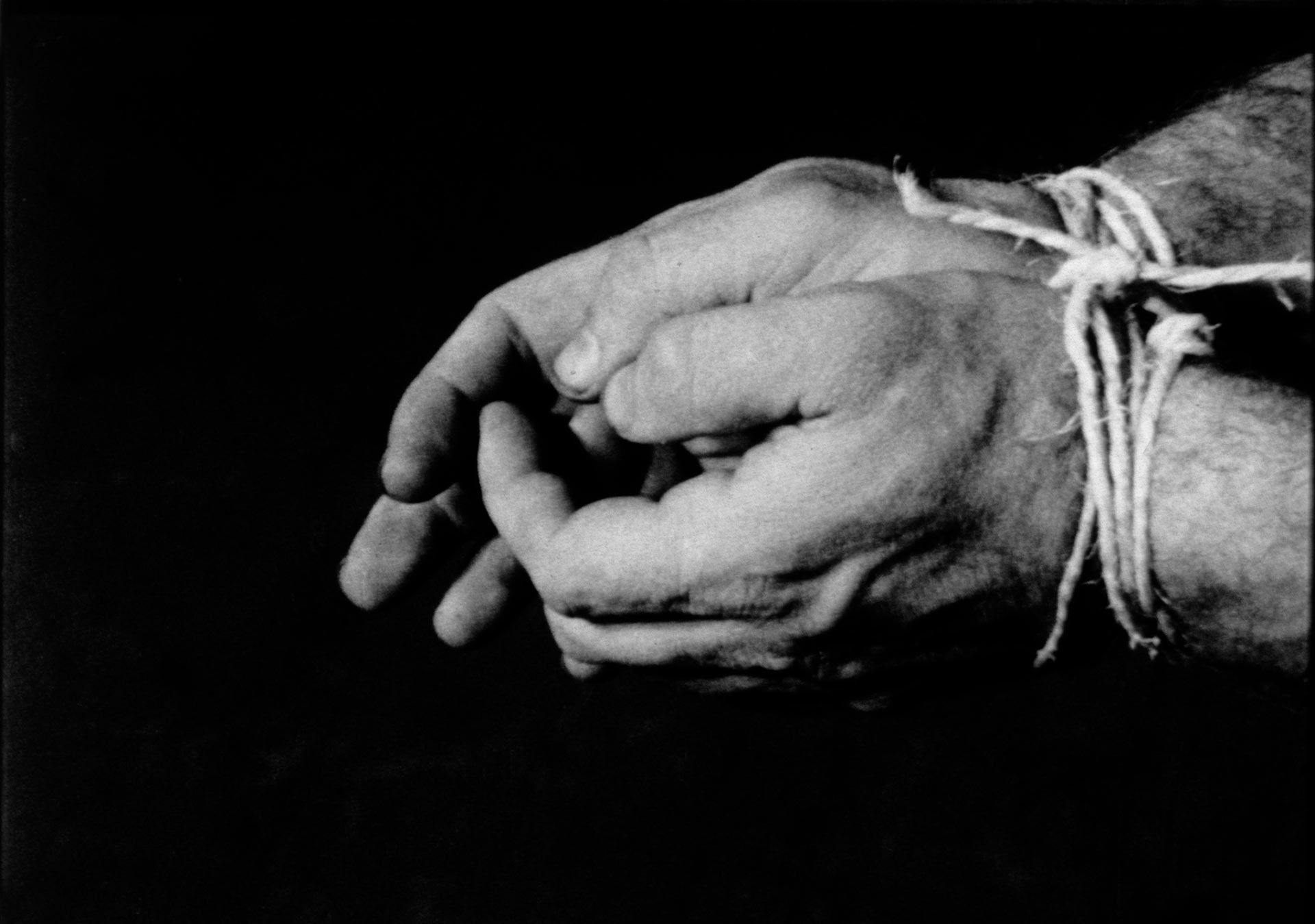 A black and white video by Richard Serra titled Hands Tied, dated 1968.