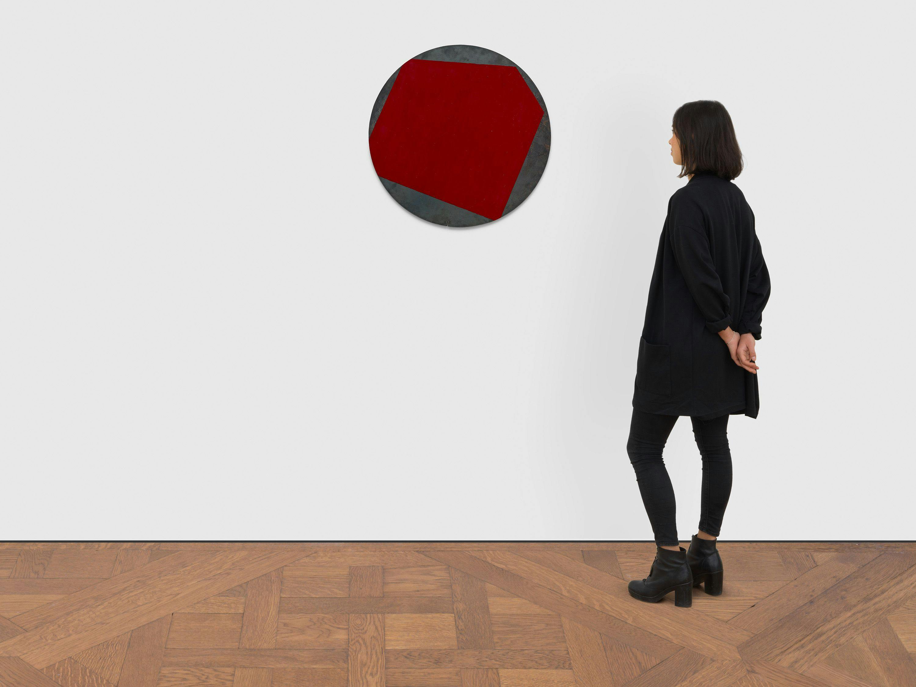 A painting on steel by Merrill Wagner, titled Red Circle, dated 1990.